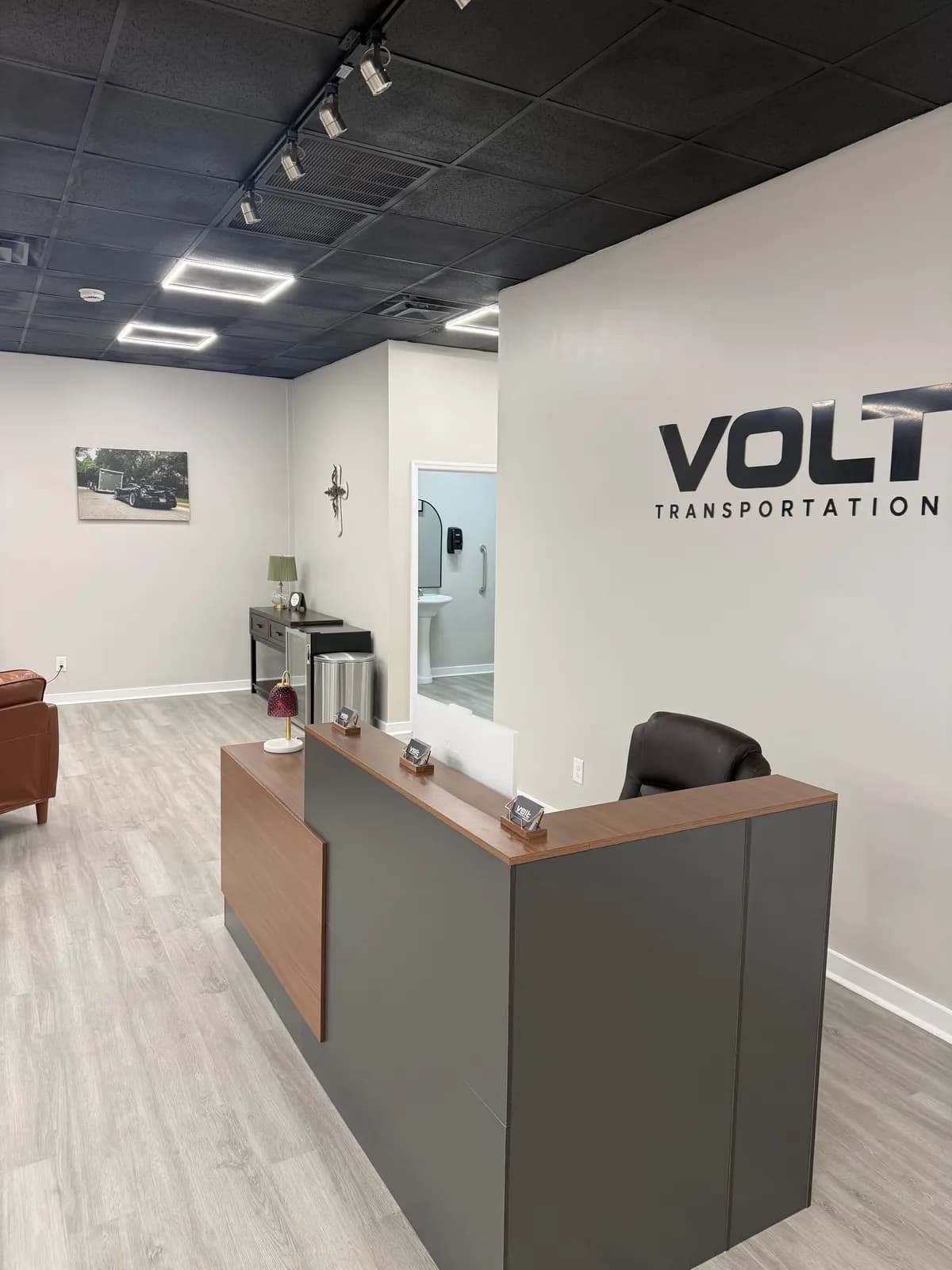 Volt Transportation front desk with the Volt logo on the wall