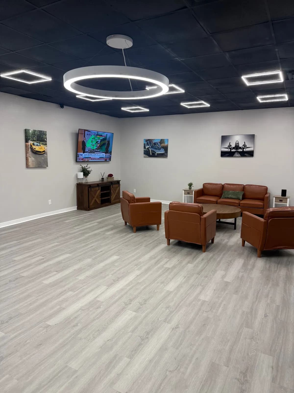 The Volt Transportation lobby with leather seating, wall art, and a TV